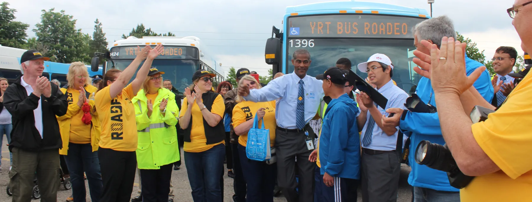 Miller Transit operators and staff cheering beside a York Region Transit bus at the Roadeo.
